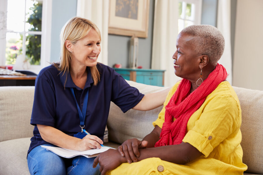 A healthcare worker chatting to a lady